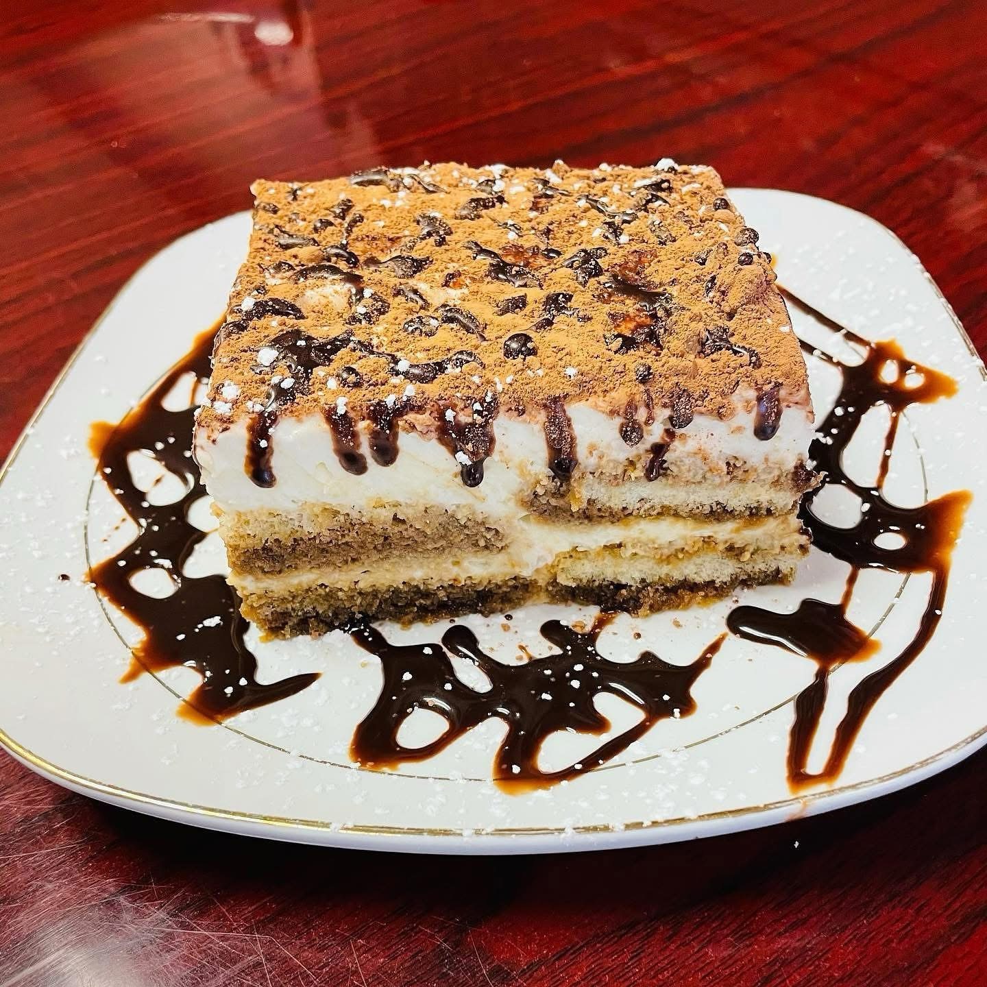 Layered dessert with chocolate drizzle